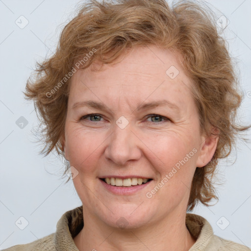 Joyful white adult female with medium  brown hair and blue eyes