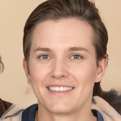 Joyful white young-adult male with medium  brown hair and grey eyes