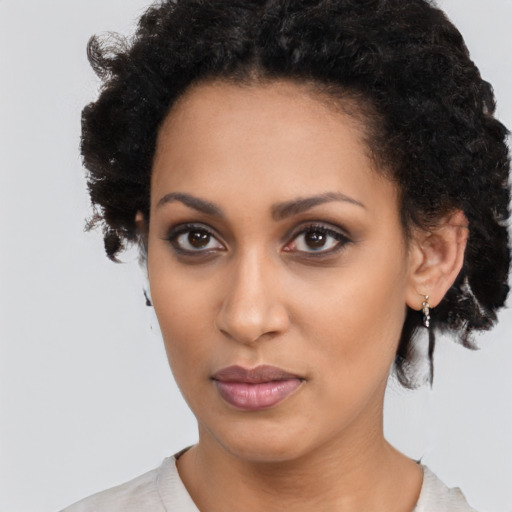 Neutral black young-adult female with medium  brown hair and brown eyes