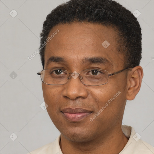 Joyful black adult male with short  black hair and brown eyes