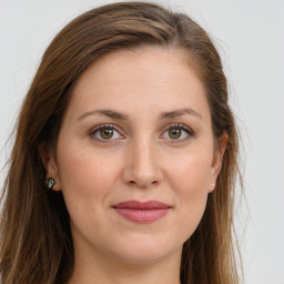 Joyful white young-adult female with long  brown hair and green eyes