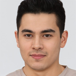 Joyful latino young-adult male with short  brown hair and brown eyes