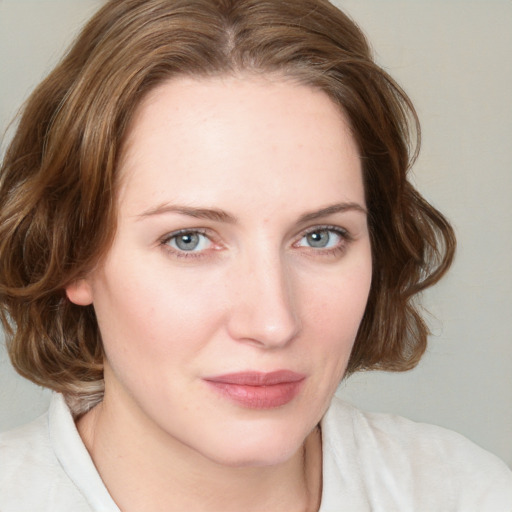 Joyful white young-adult female with medium  brown hair and blue eyes