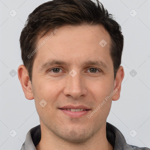 Joyful white adult male with short  brown hair and brown eyes