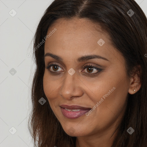 Joyful white young-adult female with long  brown hair and brown eyes