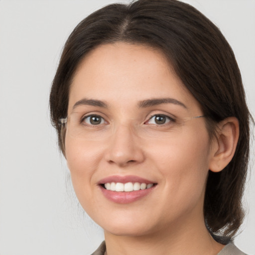 Joyful white young-adult female with medium  brown hair and brown eyes