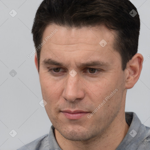 Joyful white adult male with short  brown hair and brown eyes