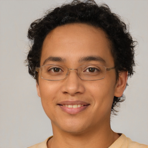 Joyful latino young-adult male with short  brown hair and brown eyes