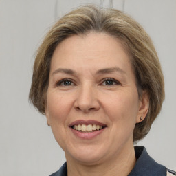 Joyful white adult female with medium  brown hair and grey eyes