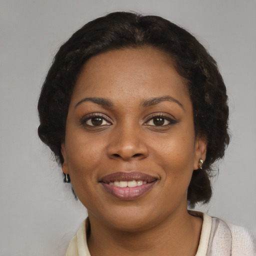 Joyful black young-adult female with medium  brown hair and brown eyes