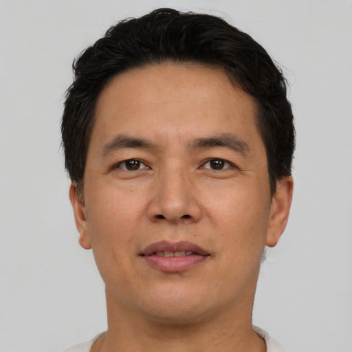 Joyful asian adult male with short  brown hair and brown eyes