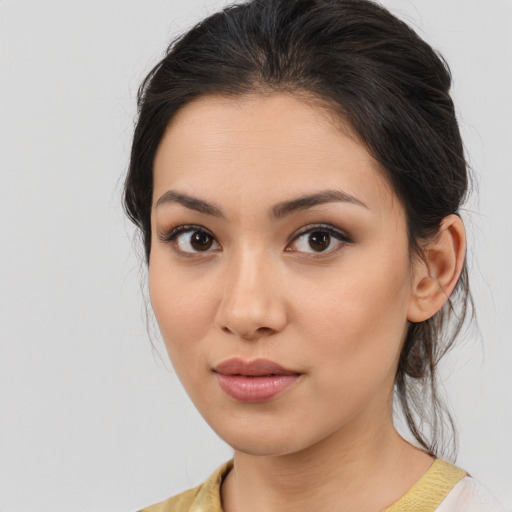 Joyful latino young-adult female with medium  brown hair and brown eyes
