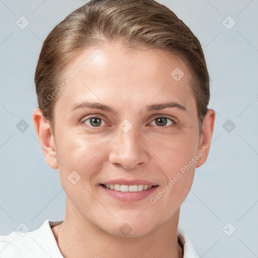 Joyful white young-adult female with short  brown hair and grey eyes