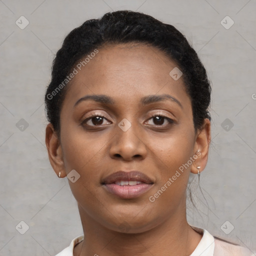 Joyful black young-adult female with short  brown hair and brown eyes