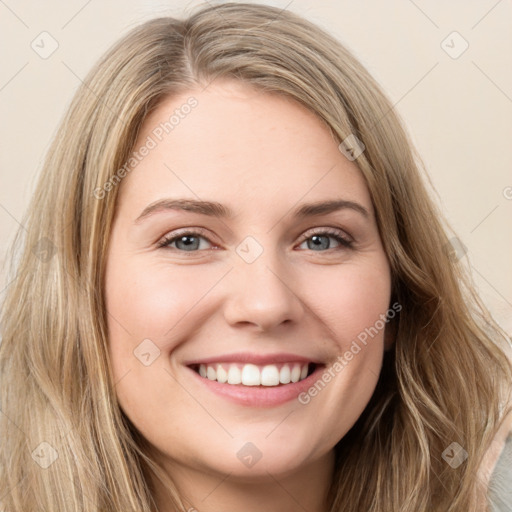 Joyful white young-adult female with long  brown hair and green eyes