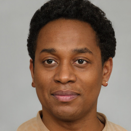 Joyful black young-adult male with short  black hair and brown eyes