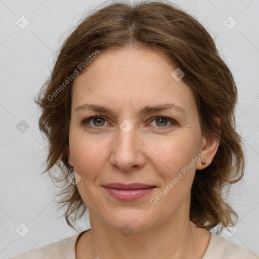 Joyful white adult female with medium  brown hair and green eyes