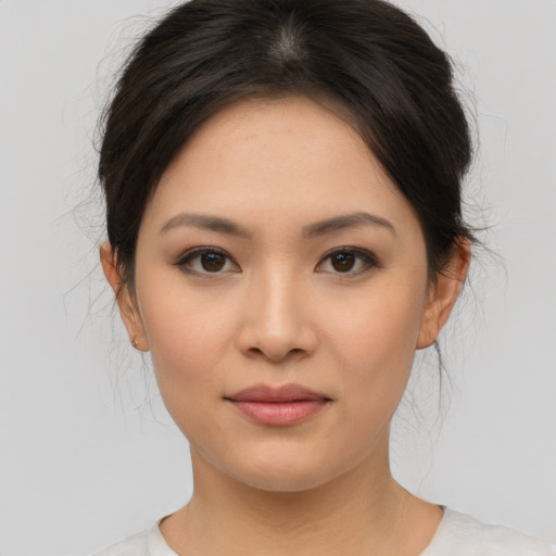 Joyful asian young-adult female with medium  brown hair and brown eyes
