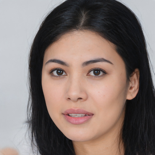 Joyful asian young-adult female with long  black hair and brown eyes
