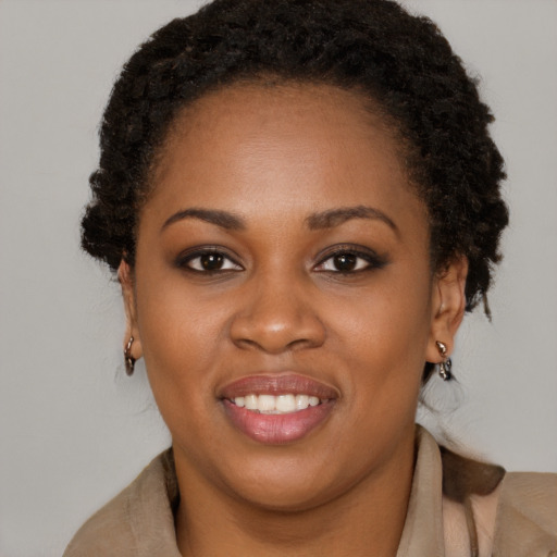Joyful black young-adult female with short  brown hair and brown eyes