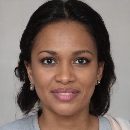Joyful black young-adult female with medium  brown hair and brown eyes