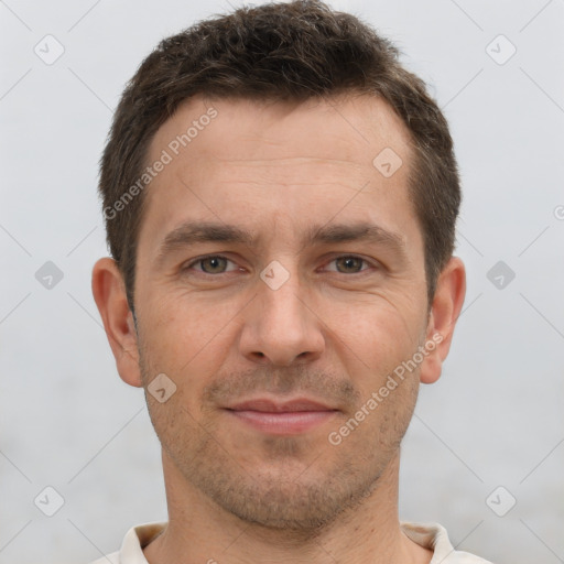 Joyful white adult male with short  brown hair and brown eyes