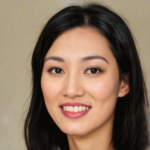 Joyful latino young-adult female with long  black hair and brown eyes