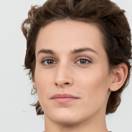 Joyful white young-adult female with medium  brown hair and green eyes