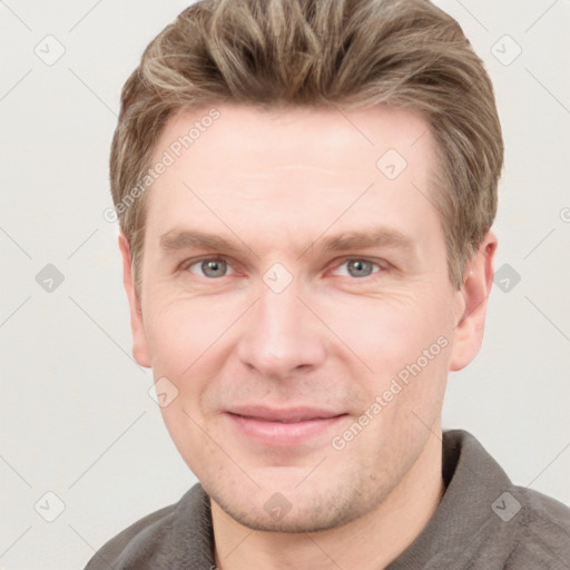 Joyful white adult male with short  brown hair and grey eyes