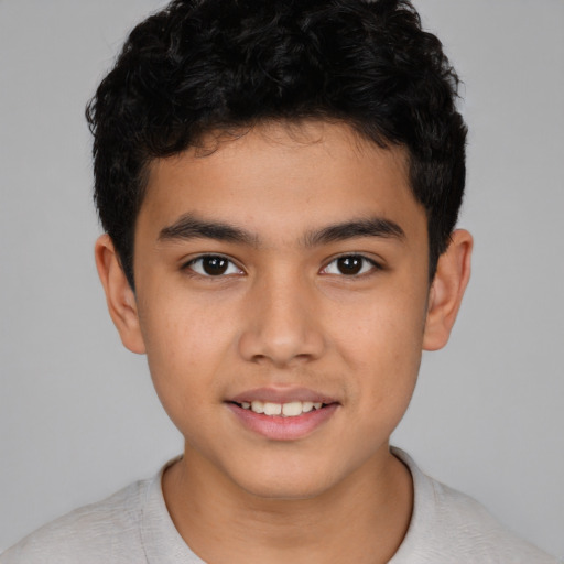Joyful latino child male with short  brown hair and brown eyes