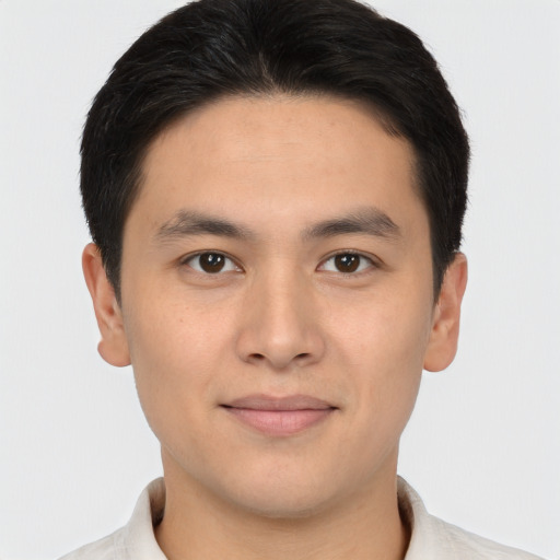 Joyful asian young-adult male with short  brown hair and brown eyes