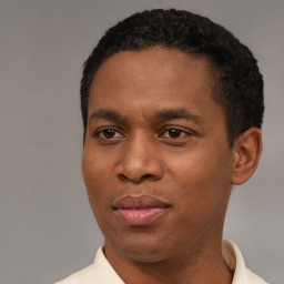 Joyful black young-adult male with short  black hair and brown eyes