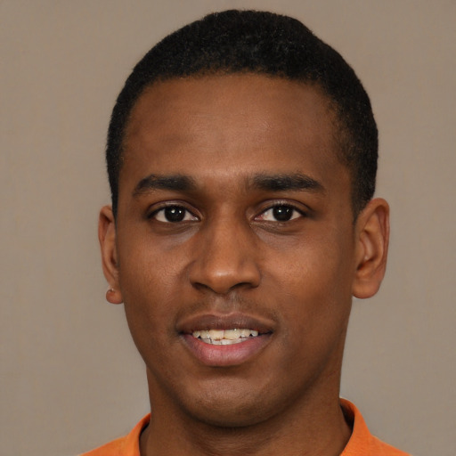 Joyful black young-adult male with short  black hair and brown eyes