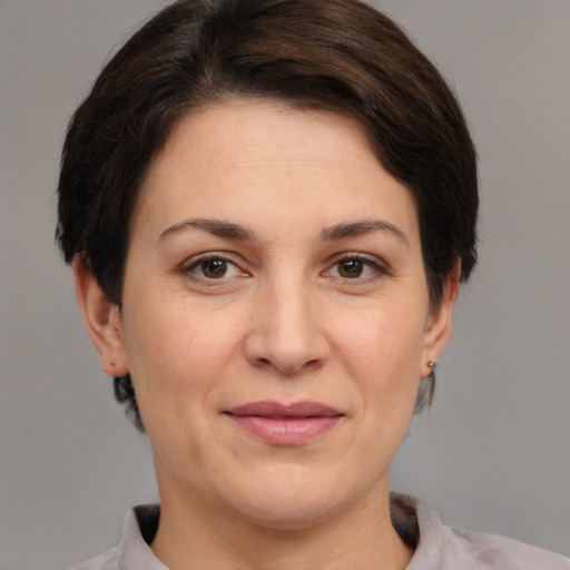 Joyful white adult female with medium  brown hair and brown eyes