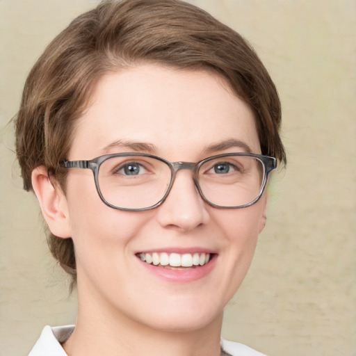 Joyful white young-adult female with medium  brown hair and green eyes