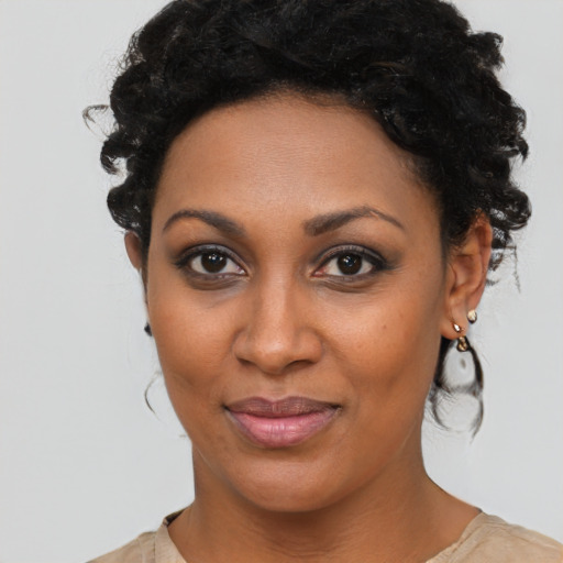 Joyful black young-adult female with medium  brown hair and brown eyes
