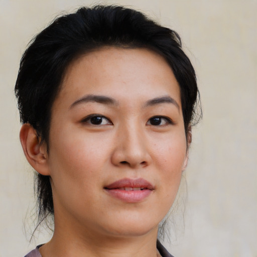 Joyful white young-adult female with short  black hair and brown eyes
