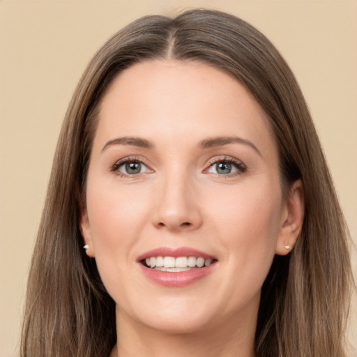 Joyful white young-adult female with long  brown hair and grey eyes