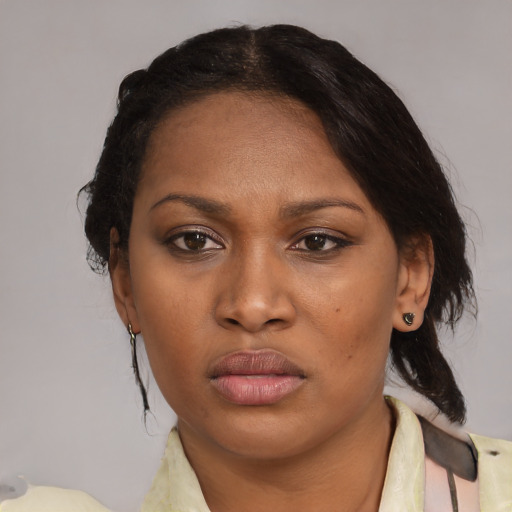 Joyful black adult female with medium  brown hair and brown eyes