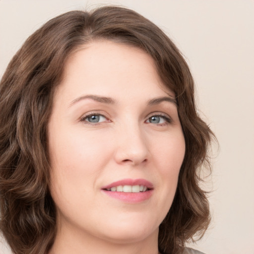 Joyful white young-adult female with long  brown hair and green eyes