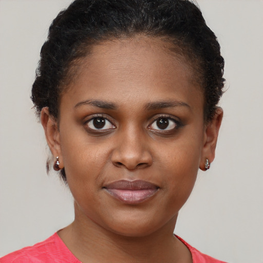 Joyful black young-adult female with short  brown hair and brown eyes