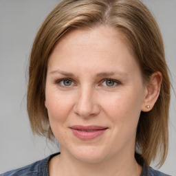 Joyful white adult female with medium  brown hair and grey eyes