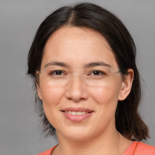 Joyful white adult female with medium  brown hair and brown eyes