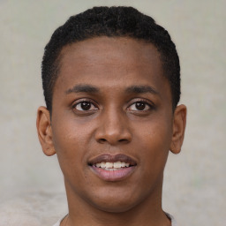 Joyful black young-adult male with short  brown hair and brown eyes