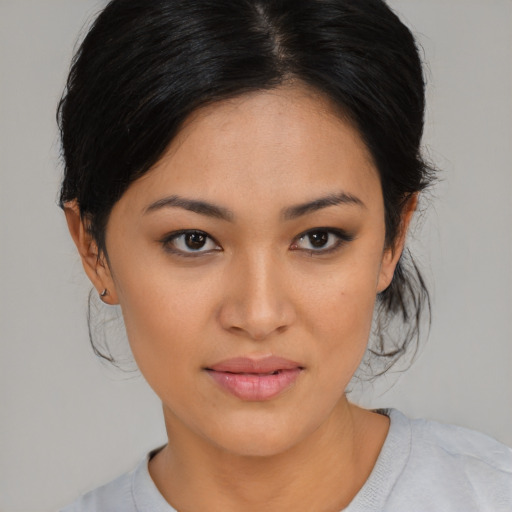 Joyful asian young-adult female with medium  black hair and brown eyes
