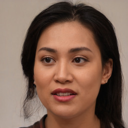 Joyful asian young-adult female with long  brown hair and brown eyes