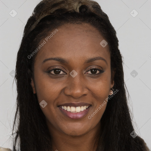 Joyful black young-adult female with long  brown hair and brown eyes