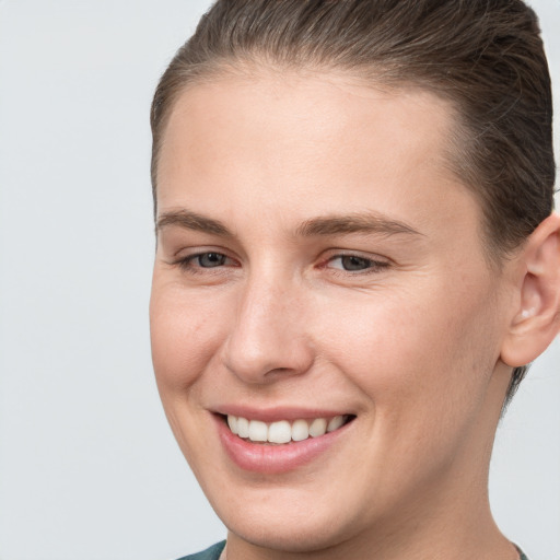 Joyful white young-adult female with short  brown hair and brown eyes