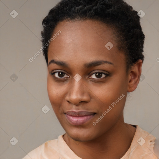 Joyful black young-adult female with short  black hair and brown eyes