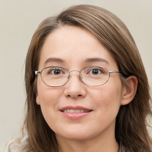 Joyful white young-adult female with long  brown hair and blue eyes